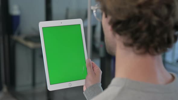 Rear View of Young Businessman Using Laptop with Chroma Screen