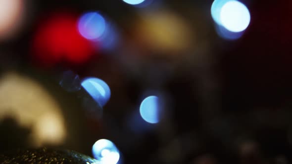 Close-up of christmas bauble with christmas lights