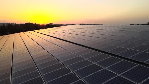 Blue Photovoltaic Solar Panels Mounted on Building Roof for Producing Clean Ecological Electricity