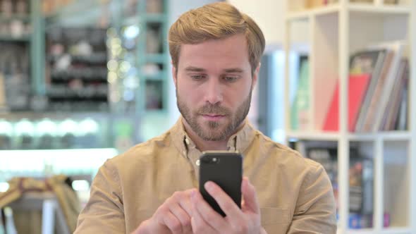 Portrait of Young Man Using Smartphone