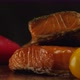 Delicious pieces of smoked salmon on black background - VideoHive Item for Sale