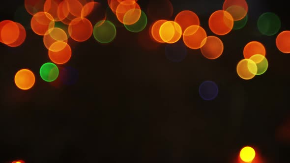 Bokeh of colorful christmas lights glowing on a plank