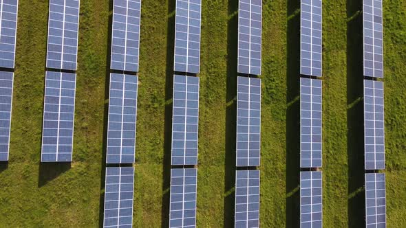 Looking down at solar farm panels on country field