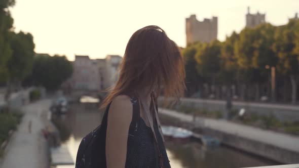 A Beautiful Woman Tourist Walks Through the Historical Center of the French City of Narbonne