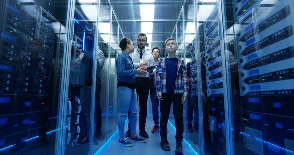 IT Technician Showing Around Children in a Server Park