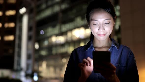 Woman looking at mobile phone in Hong Kong 