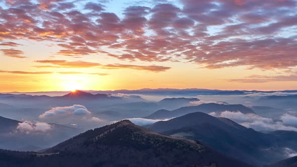 Sunrise in the Mountain Landscape Fog Spills Over Hills