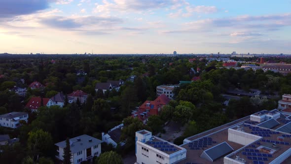 Golden hour flight over building solar library of FU Berlin Smooth aerial view flight fly backwards