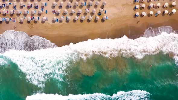 Aerial View of the Sea Sandy Beach Sun Umbrellas and Sunbeds Unrecognizable People