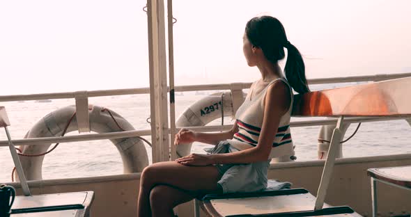 Woman Taking Ferry in Hong Kong Under Sunset Time 