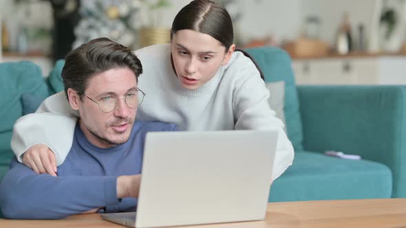 Loving Hispanic Couple Using Laptop