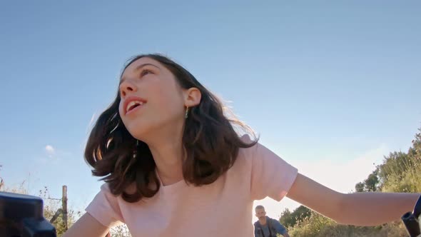 POV of a young girl enjoying a bicycle ride on the rural countryside