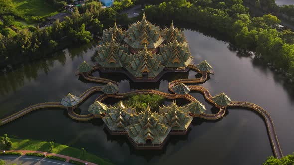 Aerial Reveal of a Green and Gold Temple on the water Ancient City Siam, Bangkok, Thailand