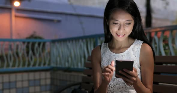 Woman using mobile phone online