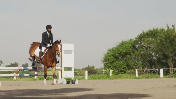 African American man jumping an obstacle with his Dressage horse