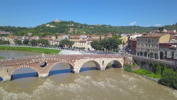 Panoramic aerial drone view of Verona, Italy. The drone moves away from the bridge Ponte Pietra