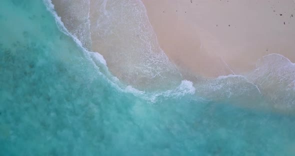 Tropical above clean view of a white sandy paradise beach and aqua turquoise water background in col