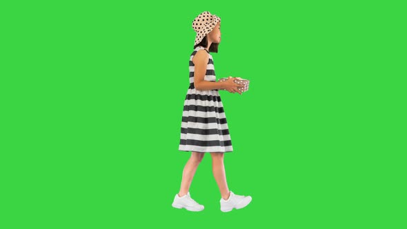 Beautiful Little Girl a Gift Box Walking on a Green Screen Chroma Key