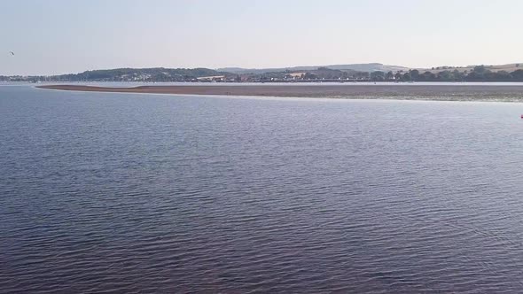 Gliding over the water of a beautiful coastal town in England whiles the birds in the sky are flying