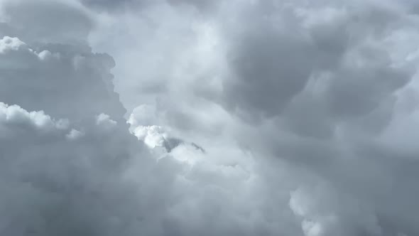 Awesome aerial view. Pilot POV, flying through stormy weather avoiding cumulonimbus in a turbulent a