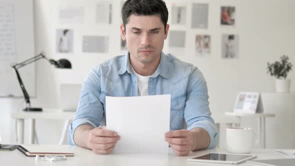 Casual Young Man Reacting to Contract Failure