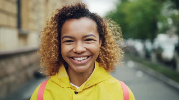 Close-up Slow Motion Portrait of Attractive Mixed Race Girl Looking at Camera with Happy Smile