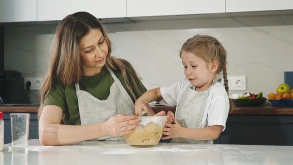 Mother and Daughter in Kitchen Prepare Dough for Cake