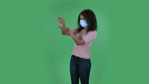 Portrait of Beautiful African American Young Woman in Medical Protective Face Mask Pours Medicine