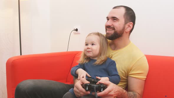 Joyful Parent Father and Sweet Cute Girl Play Video Game.