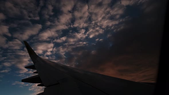 Wing of an Airplane Flying Between the Clouds