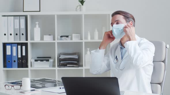 Professional medical doctor working in hospital office using computer technology.