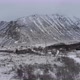Frozen landscape with snow and ice on the road, a big mountain in the background - VideoHive Item for Sale