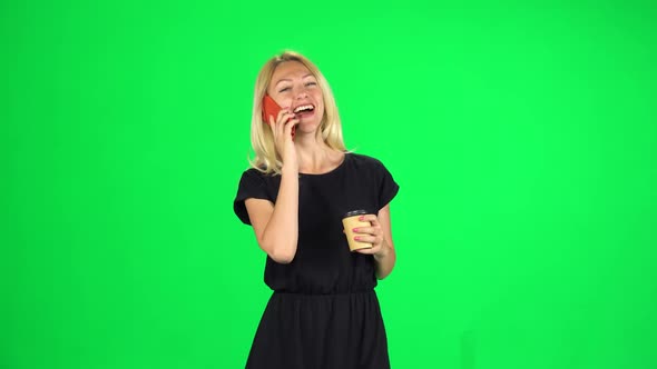 Cute Girl Goes and Speaks By Phone While Drinking a Coffee