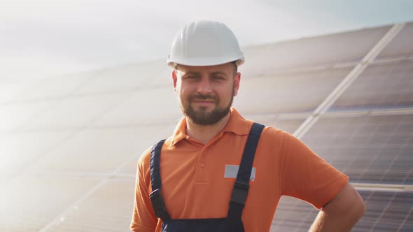 Close Up Portrait of Male Electrical Worker in Protective Helmet Standing Near