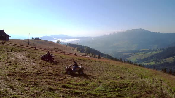People Driving Quad Bikes on Mountain Hill in Summer