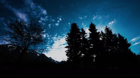 4K Sunset in Şavşat. Sun Time Lapse,  Cloud  Background, Blue sky. Silhouette of trees. Timelapse Sk