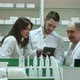 Smiling Team of Pharmacists, Two Male and One Female, Stand Side By Side in the Pharmacy Checking - VideoHive Item for Sale