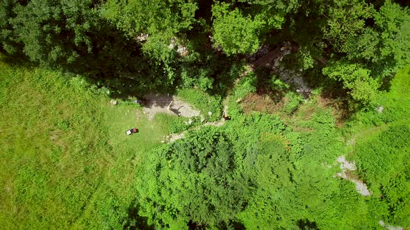 Aerial view of a person going across the Soca River on a zip line in Slovenia.