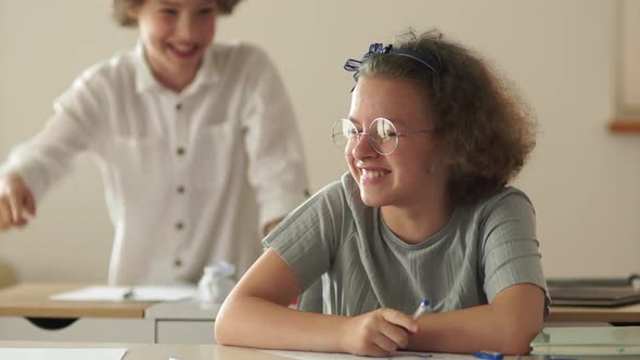 Children at School Laugh During the Lesson. The Boy and the Girl Have Fun at School. Back To School