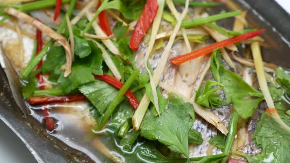 Close-up Footage of Steamed Sea Bass in Soy Sauce Soup, Chinese-Thai Popular Dish, The Combination o