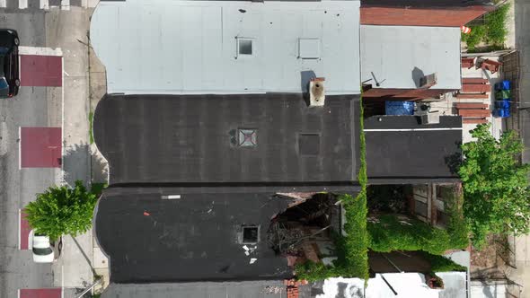 Top down aerial of homes in disrepair in inner city urban neighborhood in USA. Abandoned unsafe livi