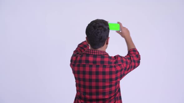 Happy Young Hispanic Hipster Man Taking Picture with Phone
