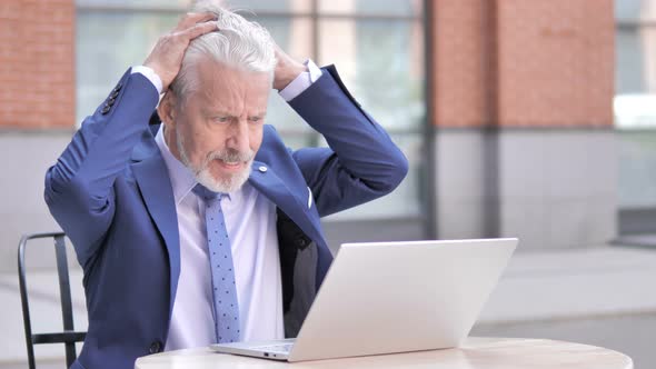 Angry Old Businessman Working on Laptop