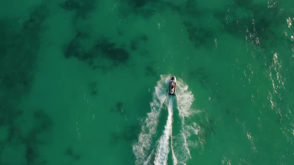 Couple Riding Jet Ski on the Calm Sea