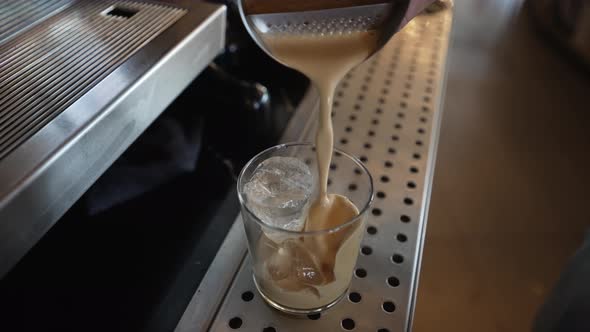 Pouring Fredo Espresso in Glass with Ice, Barista Work at Cafe