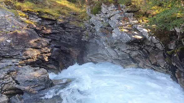 rushing water of a mountain rive  in a gorge of rugged rocks