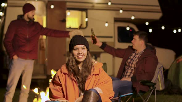 Girl Sitting on a Camping Chair in a Cold Night of Autumn