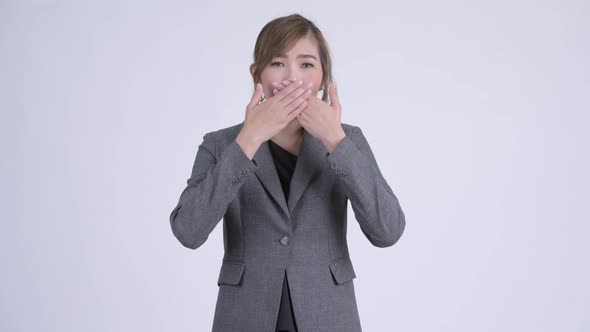 Young Beautiful Asian Businesswoman Covering Mouth As Three Wise Monkeys Concept