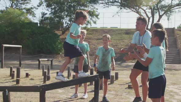 Group of Caucasian children training at boot camp