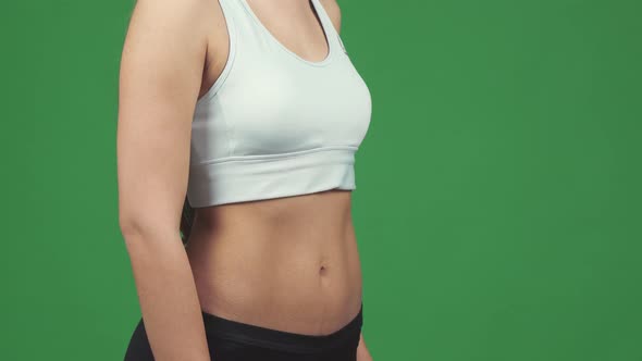 Cropped Shot of a Sportswoman Showing Thumbs Up Holding Water Bottle